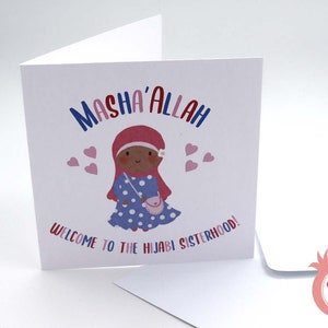 May include: A white card with a cartoon illustration of a girl wearing a pink headscarf and a blue polka dot dress. The text "Masha'Allah" is written in red, blue, and pink letters. The text "Welcome to the Hijabi Sisterhood!" is written in black letters.