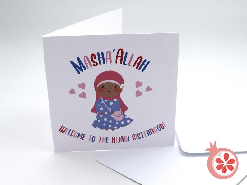 May include: A white card with a cartoon illustration of a girl wearing a pink headscarf and a blue polka dot dress. The text "Masha'Allah" is written in red, blue, and pink letters. The text "Welcome to the Hijabi Sisterhood!" is written in black letters.