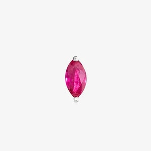 May include: A single ruby marquise-shaped gemstone earring in a silver setting.