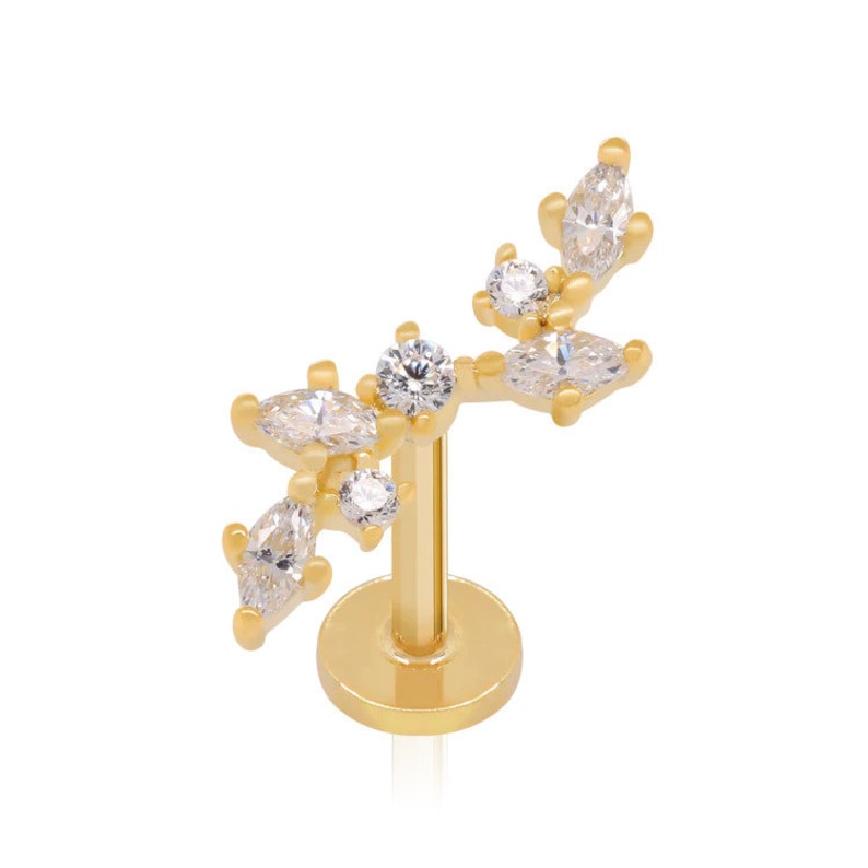May include: Gold body jewelry with a cluster of clear cubic zirconia stones in a leaf design.