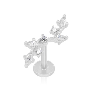 May include: A silver body jewelry piece with a cluster of clear cubic zirconia stones in a leaf-like design. The piece is designed for a cartilage piercing.