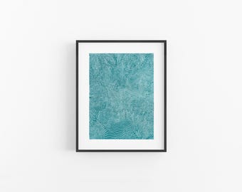 May include: A framed wall art print featuring a teal background with intricate, dense white topographic contour lines that create a complex, flowing pattern across the entire rectangular surface, enclosed in a thin black frame.