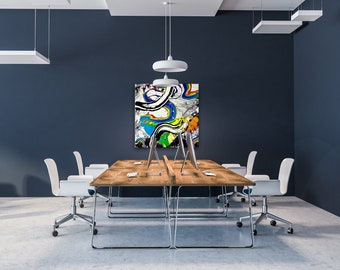 May include: A modern office space with a long wooden table and white chairs. The table has four computer monitors and keyboards. A colorful abstract painting hangs on the wall behind the table.