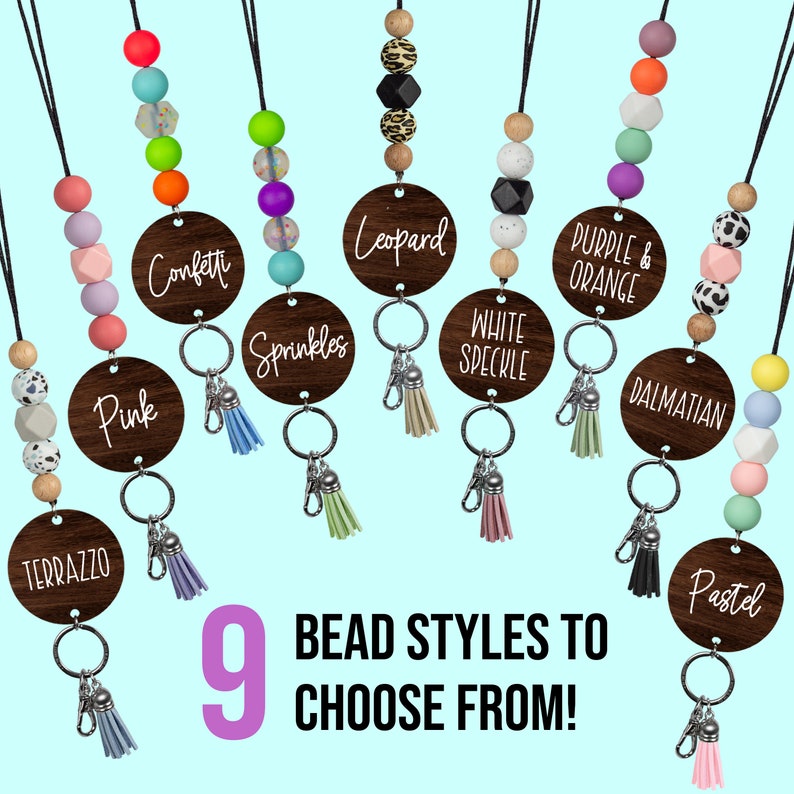 May include: Nine different styles of colorful beaded keychains with wooden round tags. The tags have different text on them, including "Pink", "Terrazzo", "Confetti", "Sprinkles", "Leopard", "White Speckle", "Purple & Orange", "Dalmatian", and "Pastel".