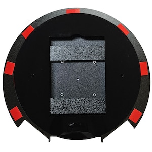May include: Black circular base with a red trim and a rectangular cutout in the center. The cutout has a textured black surface.