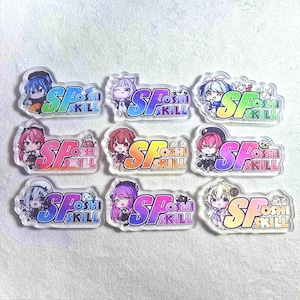 May include: A collection of nine clear acrylic charms featuring anime-style characters. Each charm has a unique character design and the text "SP OSHI SKILL" in a gradient color scheme. The charms are on a white surface.