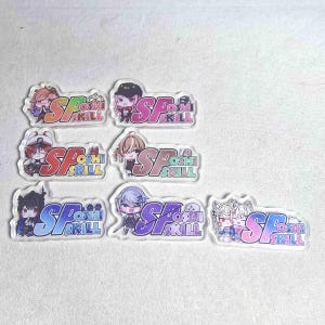 May include: A collection of seven clear acrylic charms featuring anime-style characters and the text "SP Oshi Skill". Each charm has a unique character design with vibrant colors and a gradient background.