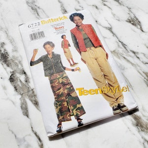 May include: A sewing pattern for a teen girl's outfit. The pattern is for a camouflage skirt and a red vest. The pattern is from Butterick and is number 6722.