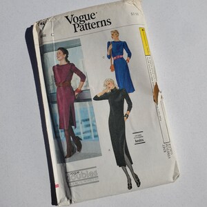May include: Vintage Vogue Patterns sewing pattern featuring illustrations of three dresses. The pattern envelope is off-white with the text "Vogue Patterns" and the price $3.50. The dresses are in shades of burgundy, blue, and black.