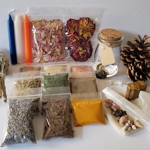 May include: A collection of items for a spell or ritual, including candles, herbs, crystals, dried flowers, and a pine cone.