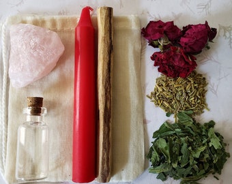May include: A white cloth bag filled with various items for a love spell, including a pink rose quartz crystal, a red candle, a wooden stick, a small glass bottle, dried rose petals, dried rosemary, and dried green leaves.