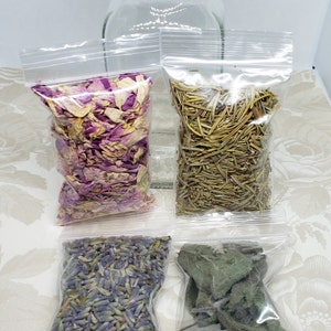 May include: Four small clear plastic bags filled with dried herbs and flowers. The bags contain dried lavender flowers, dried rose petals, dried rosemary sprigs, and dried sage leaves.