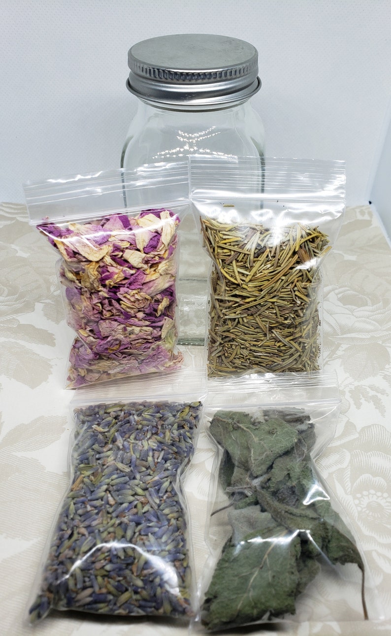 May include: Four small clear plastic bags filled with dried herbs and flowers. The bags contain dried lavender flowers, dried rose petals, dried rosemary sprigs, and dried sage leaves.