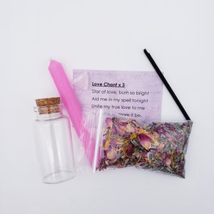May include: A love spell kit with a pink candle, a small glass bottle with a cork stopper, a bag of dried herbs and flowers, and a black incense stick. The kit includes a card with the text "Love Chant x 3 Star of love, burn so bright Aid me in my spell tonight Unite my true love to me more it be."