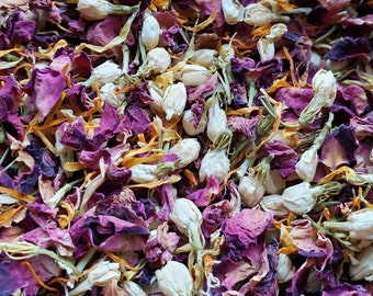 May include: A mix of dried rose petals, jasmine blossoms, and marigold petals. The petals are a mix of purple, pink, yellow, and white.