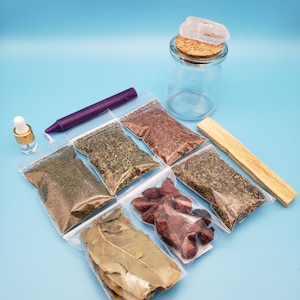 May include: A collection of herbs, spices, and other ingredients for a spell or ritual. The items include dried herbs in clear plastic bags, a purple candle, a clear glass jar with a cork stopper, a small wooden stick, and a clear quartz crystal.