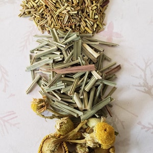 May include: A mix of dried herbs including rosemary, lemongrass, and chamomile flowers.