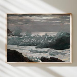 May include: A framed print of a seascape painting. The artwork shows crashing waves and rocky cliffs under a cloudy sky. The text "I am the rock against which the surf crashes" is written across the image.