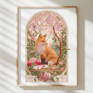 May include: Framed art print depicting a fox with orange and white fur, holding a bow and arrow. The fox is set against a stained-glass window design with pink roses and a floral border. Two red apples are in the foreground.