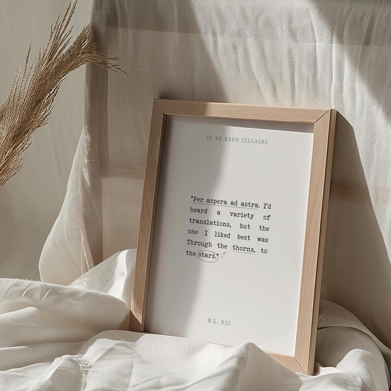 May include: A framed print with a white background and black text. The text reads "IF WE WERE VILLAINS" and "'Per aspera ad astra. I'd heard a variety of translations, but the one I liked best was Through the thorns, to the stars.'" The text is attributed to "M.L. BIO".