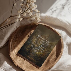 May include: A wooden tray holds a card with the text "Once upon a time..." against a forest and castle backdrop. White flowers and soft fabric surround the tray, creating a fairytale theme.