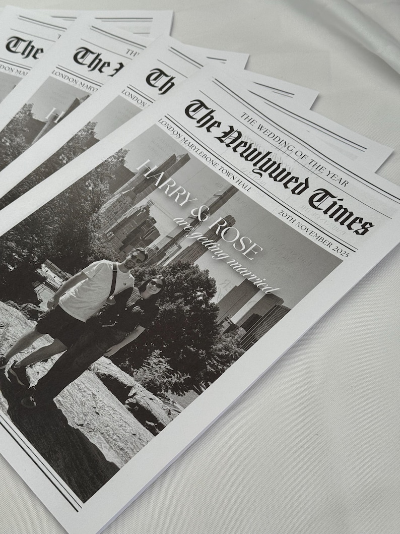 May include: Several black and white wedding announcement cards. The headline reads "The Newlywed Times" with the date "20th November 2025". The names "HARRY & ROSE" are featured prominently. The cards are stacked on a white surface.