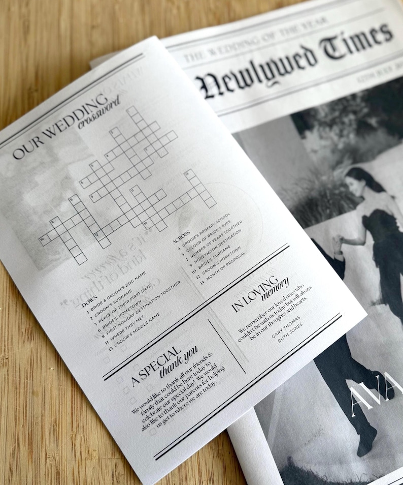 May include: Two wedding-themed newspapers are displayed. One features a crossword puzzle titled "OUR WEDDING crossword" with clues. The other newspaper is titled "THE WEDDING OF THE YEAR Newlywed Times" with a photo and text.