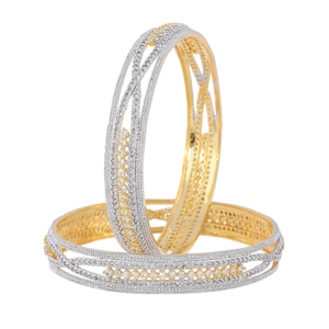 May include: Two gold and silver bangles with a clear rhinestone design. The bangles are stacked on top of each other.