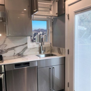 European Dish Rack Above the Sink. Dish Drying Rack Built Inside the Cabinet