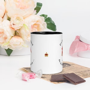 May include: White ceramic mug with a black rim. The mug has a black and red illustration of a person wearing a crown and the text "You'll never get da... da da da... back".