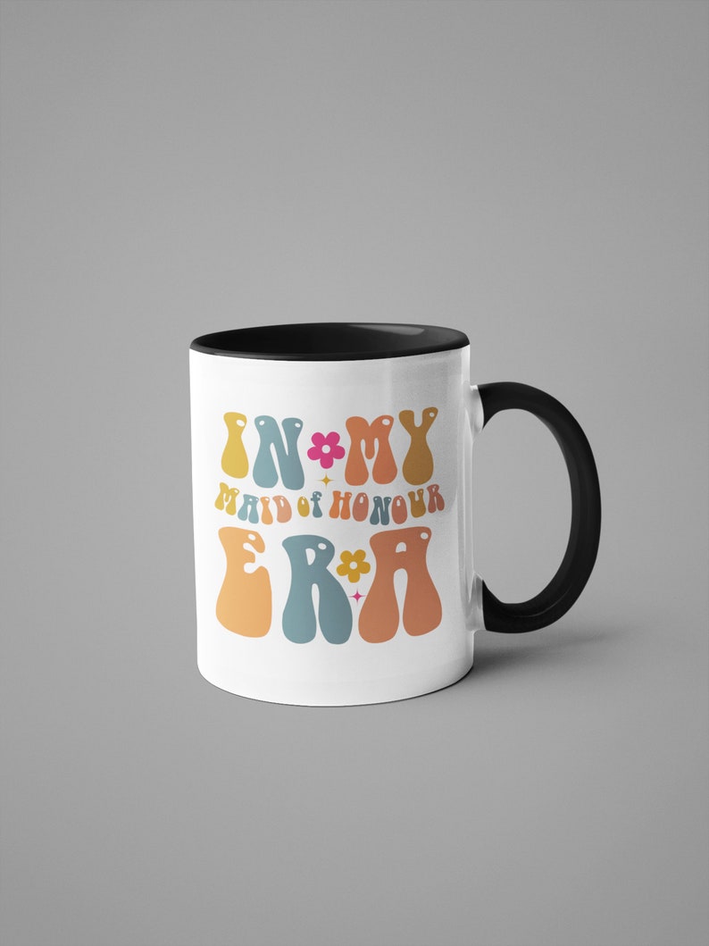 May include: White ceramic mug with a black rim and handle. The mug features a colorful retro design with the text "In My Maid of Honour Era" in a groovy font.