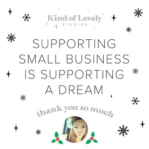 May include: A white background with black snowflakes and stars. The text "Supporting small business is supporting a dream" is in black text. The text "thank you so much" is in gray text and is curved around a photo of a woman with blonde hair. The text "Kind of Lovely Studios" is in gray text.