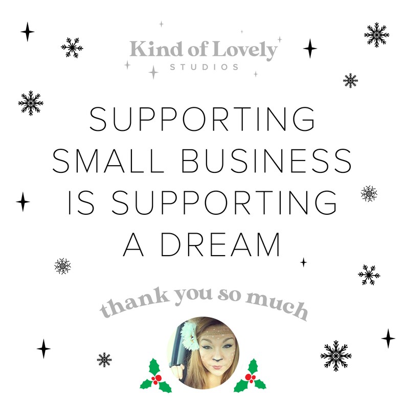 May include: A white background with black snowflakes and stars. The text "Supporting small business is supporting a dream" is in black text. The text "thank you so much" is in gray text and is curved around a photo of a woman with blonde hair. The text "Kind of Lovely Studios" is in gray text.