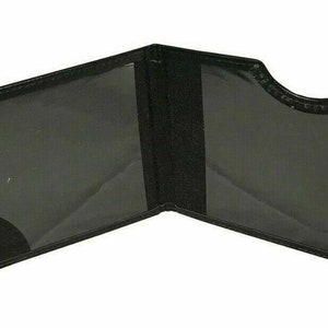 May include: Black leather card holder with silver corners and a clear plastic window. The holder is open and the inside is visible.