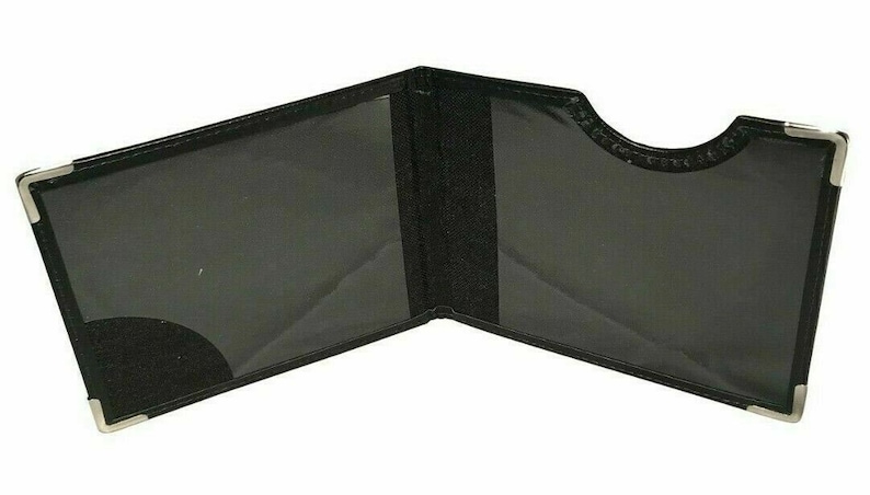May include: Black leather card holder with silver corners and a clear plastic window. The holder is open and the inside is visible.