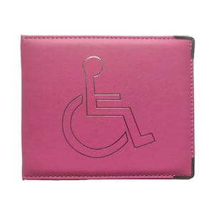 May include: Pink leather disabled parking permit holder with a silver wheelchair symbol embossed on the front.