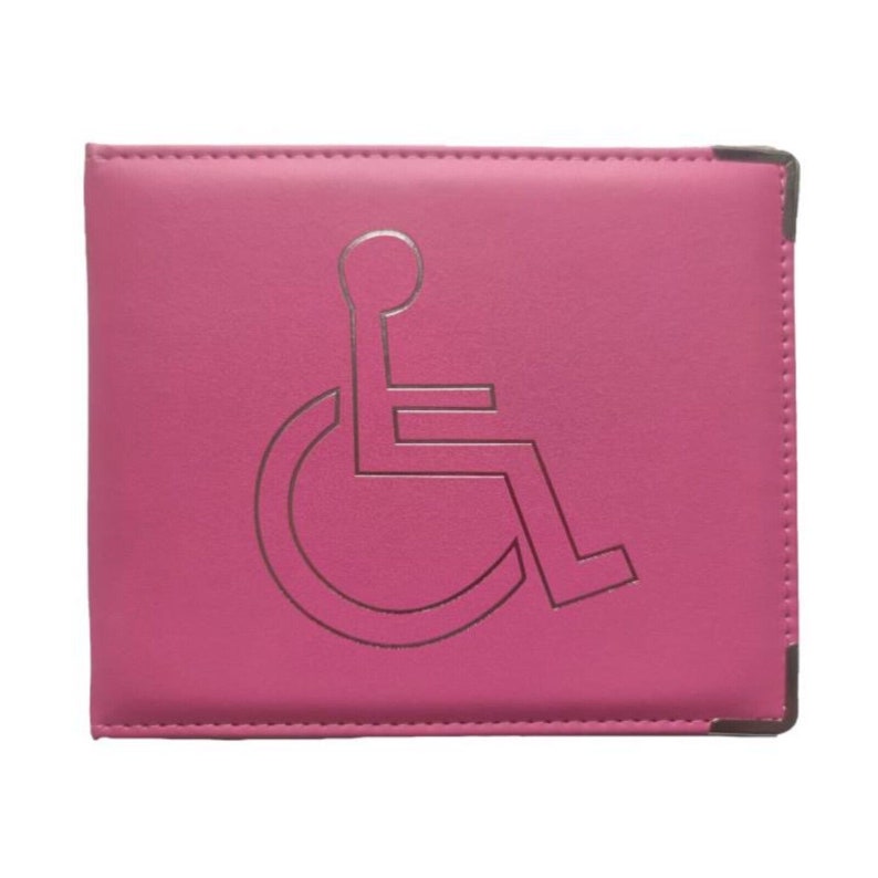 May include: Pink leather disabled parking permit holder with a silver wheelchair symbol embossed on the front.