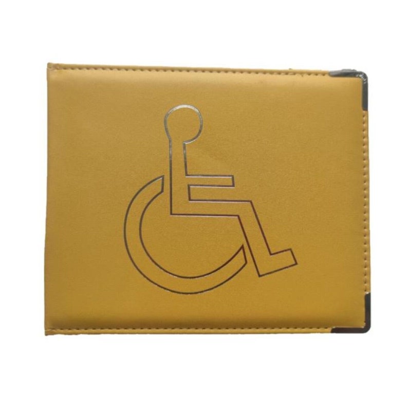 May include: A yellow leather disabled parking permit holder with a silver wheelchair symbol.
