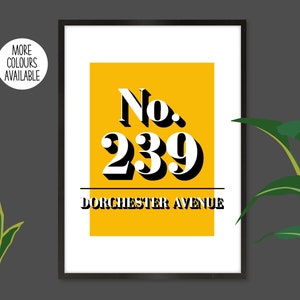 May include: A white framed print with a yellow background and black text. The text reads "No. 239 DORCHESTER AVENUE".