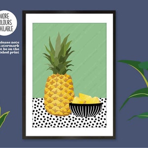 May include: A framed print of a pineapple and pineapple slices in a black and white bowl on a black and white polka dot background. The background is a light green colour.