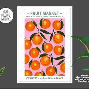 May include: A pink poster with a white border and the text "FRUIT MARKET" in black. The poster features a pattern of oranges on branches with green leaves. The text "ORANGES - NARANJAS - ARANCE" is at the bottom of the poster.