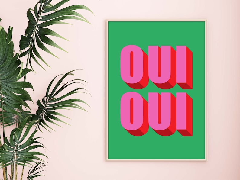 May include: A framed print with a green background and the word "OUI" written in pink and red letters.