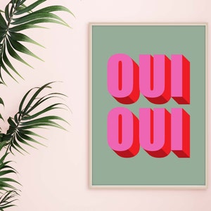 May include: A framed print with a green background and the word "OUI" written in pink and red letters with a 3D effect.