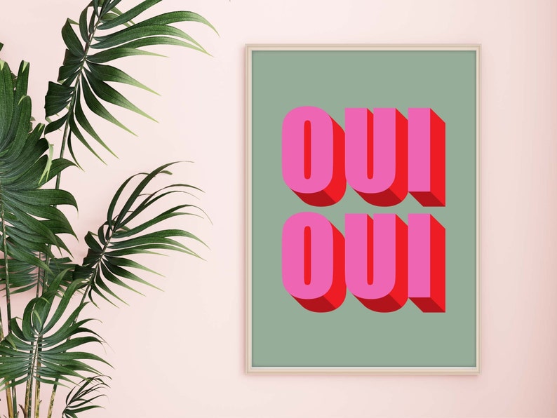 May include: A framed print with a green background and the word "OUI" written in pink and red letters with a 3D effect.