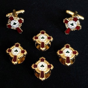 May include: Set of six gold cufflinks and buttons featuring a red and white enamel cross with a green shamrock and the text "KT. COMM. COURT OF HONOUR".