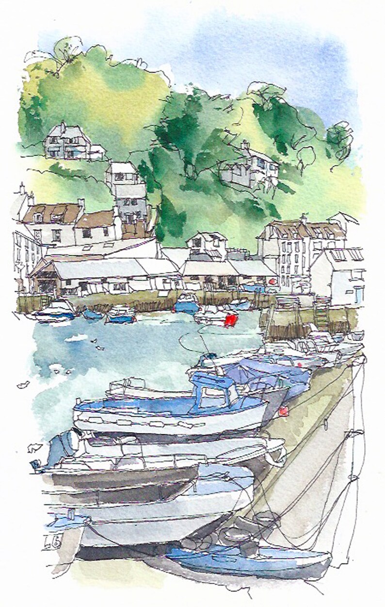 Local boats tied to the harbour wall in Polperro Harbour Cornwall