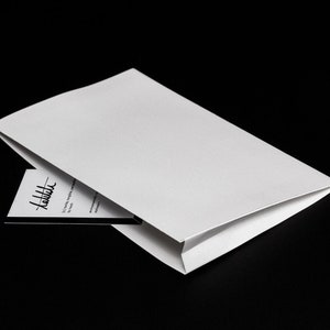 tasca di carta autoadesiva per qualsiasi notebook