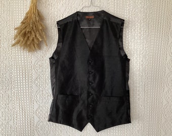 May include: A black satin waistcoat with a V-neck and five buttons. The waistcoat has two pockets on the front.
