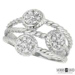 May include: A silver ring with three round clusters of small diamonds set in a rope-like band.