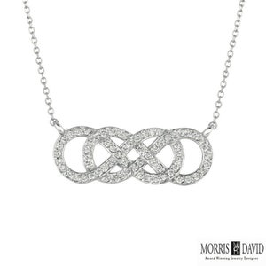 May include: A silver infinity necklace with a pave diamond design. The necklace features a continuous loop of diamonds, symbolizing eternity.
